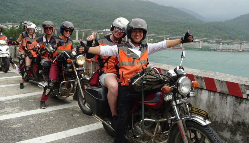 Tour guides carry their passengers on motorbikes through Lang Co Bay in Hue. Photo courtesy of Lefamily Riders
